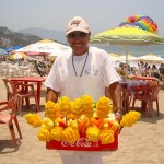 Beach Vendor Selling Artistic Mangos Beach Vendor Selling Artistic Mangos